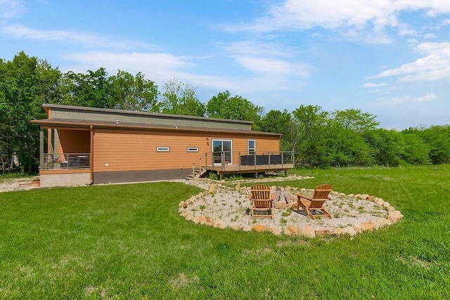 85 Birdie Ln, Mound City, KS 66056 - rear view of house with a wooden deck and a lawn