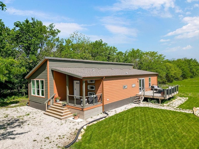 85 Birdie Ln, Mound City, KS 66056 - rear view of property featuring a yard, a deck, and roof with shingles