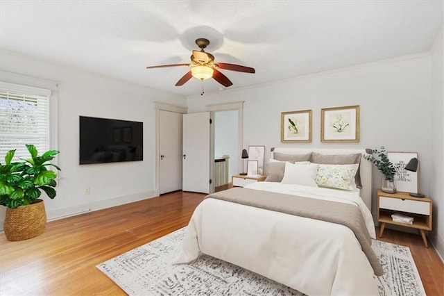18 W 61st Ter, Kansas City, MO 64113 - bedroom featuring wood finished floors, crown molding, ceiling fan, and baseboards