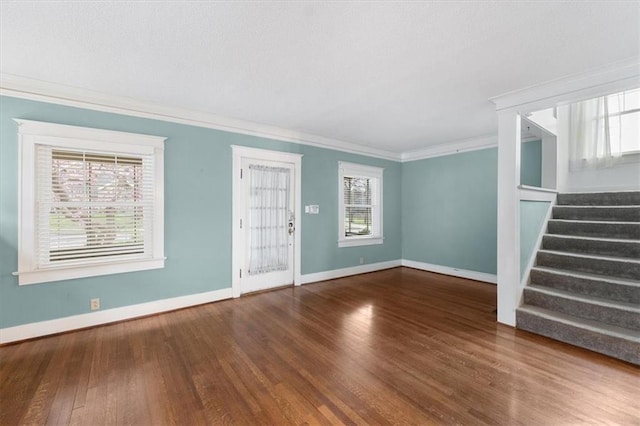 18 W 61st Ter, Kansas City, MO 64113 - unfurnished living room with crown molding, wood finished floors, stairway, and baseboards