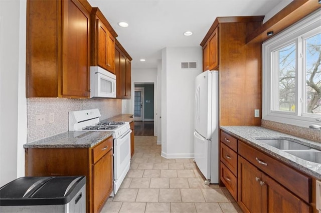 18 W 61st Ter, Kansas City, MO 64113 - kitchen featuring white appliances, decorative backsplash, stone counters, a sink, and recessed lighting