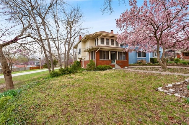 18 W 61st Ter, Kansas City, MO 64113 - view of front facade with a chimney, a front yard, and brick siding