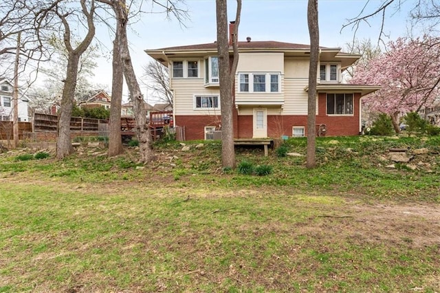 18 W 61st Ter, Kansas City, MO 64113 - rear view of house with fence and brick siding