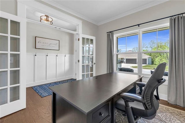 office featuring wood finished floors, french doors, and ornamental molding