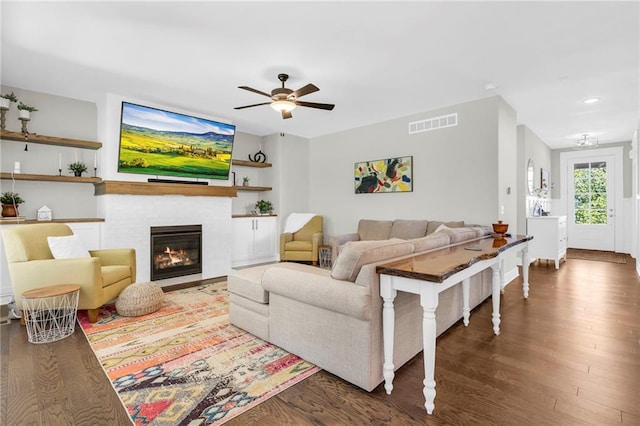 living area with wood finished floors, a ceiling fan, a tile fireplace, recessed lighting, and baseboards