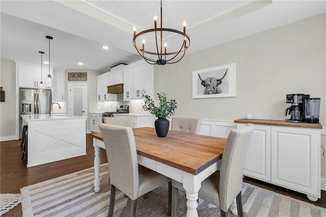 dining room with a chandelier, dark wood-style floors, recessed lighting, and a wainscoted wall