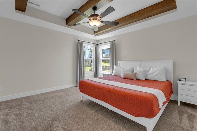 carpeted bedroom with beamed ceiling, baseboards, and a ceiling fan