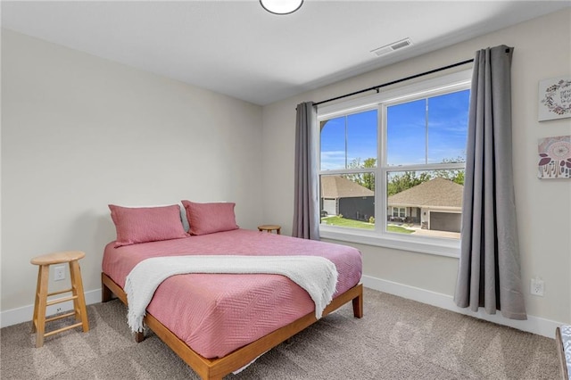 bedroom with carpet floors and baseboards