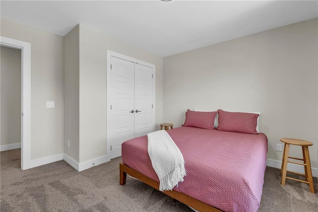carpeted bedroom featuring a closet and baseboards