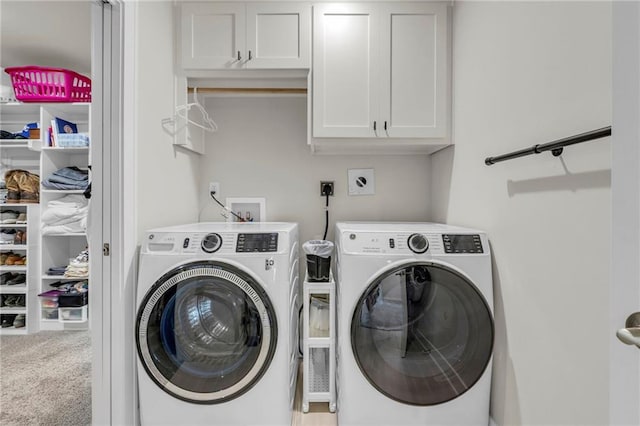 clothes washing area with washing machine and clothes dryer, cabinet space, and carpet flooring