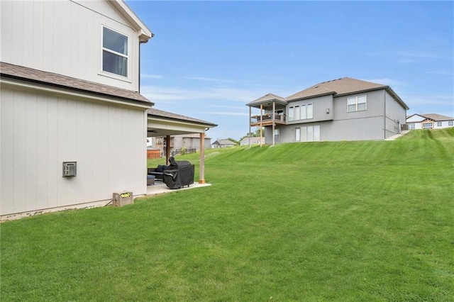 view of grassy yard with a patio