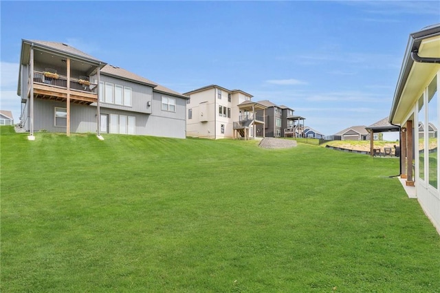 view of green lawn featuring a residential view