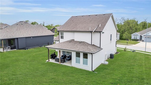 rear view of house with roof with shingles, a yard, a patio, and central AC unit
