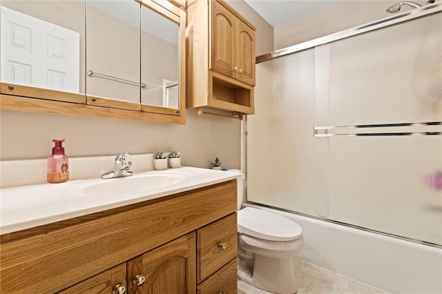 full bath featuring combined bath / shower with glass door, vanity, and toilet