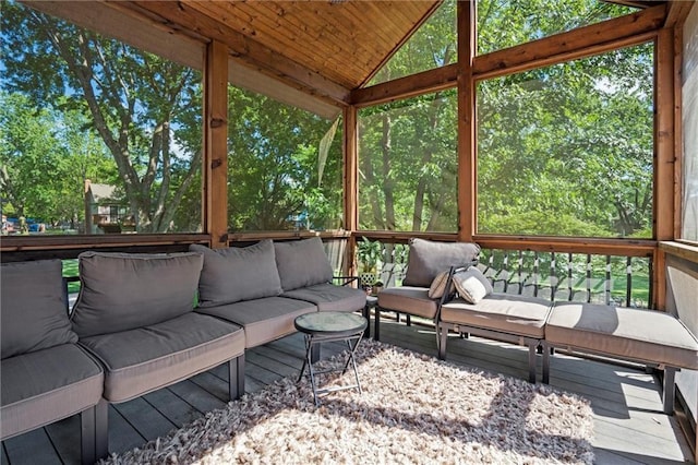 sunroom featuring an outdoor hangout area, lofted ceiling, and plenty of natural light