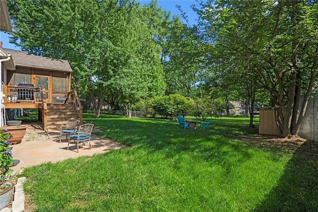 view of yard with a patio, stairs, a wooden deck, and a sunroom