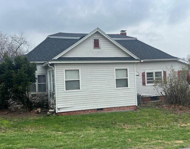 524 N Walnut St, Maryville, MO 64468 - view of side of home featuring a lawn, roof with shingles, and a chimney