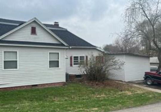 524 N Walnut St, Maryville, MO 64468 - view of property exterior with a yard and a chimney