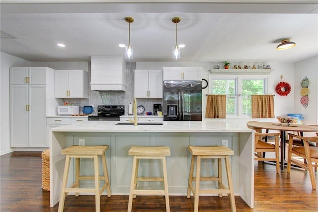 81 S Street S, St, Lake Lotawana, MO 64086 - kitchen with custom exhaust hood, stainless steel appliances, a sink, backsplash, and dark wood-type flooring