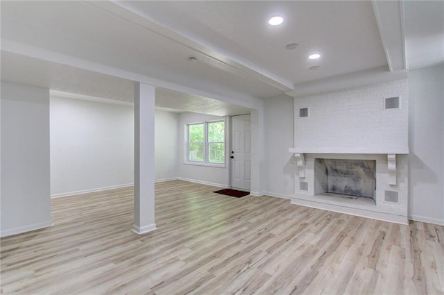 81 S Street S, St, Lake Lotawana, MO 64086 - unfurnished living room featuring wood finished floors, a brick fireplace, baseboards, and recessed lighting