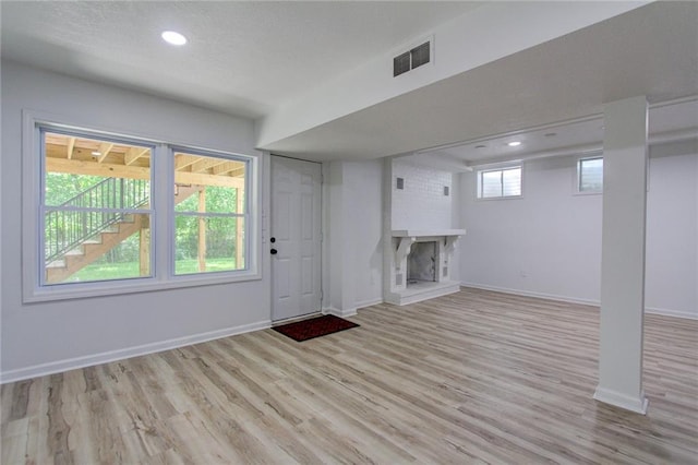81 S Street S, St, Lake Lotawana, MO 64086 - entryway with a brick fireplace, light wood-style flooring, recessed lighting, and baseboards