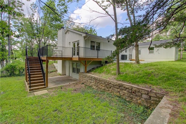 81 S Street S, St, Lake Lotawana, MO 64086 - back of property with stairs, a wooden deck, central AC, and a lawn