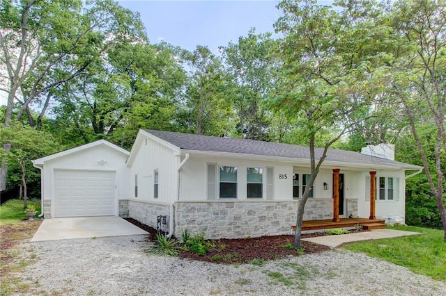 81 S Street S, St, Lake Lotawana, MO 64086 - single story home with stone siding, driveway, a porch, and a detached garage