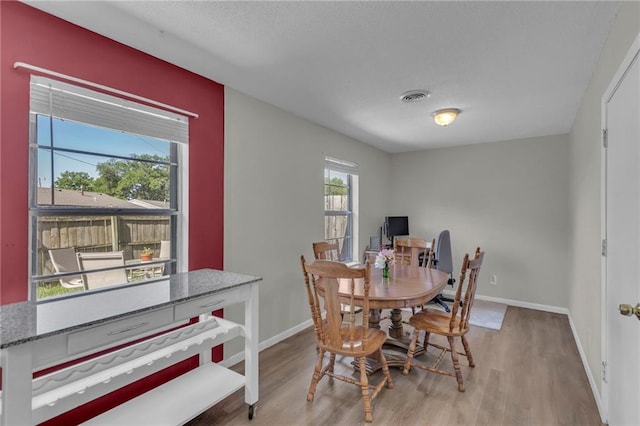 dining room featuring wood finished floors and baseboards