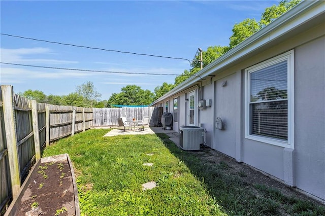 view of yard featuring cooling unit and a patio area