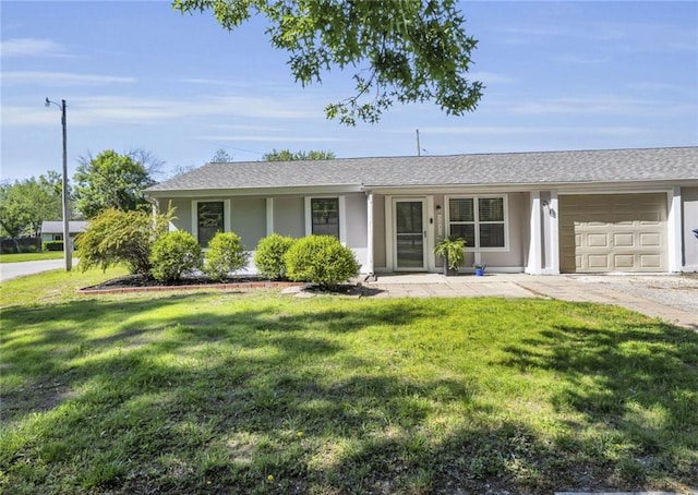 single story home with a garage, a front yard, and stucco siding