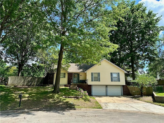504 NW Brett Cir, Blue Springs, MO 64014 - view of front facade featuring a garage, concrete driveway, and brick siding