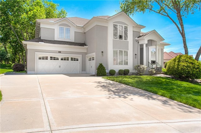 5445 NE Northgate Xing, Lees Summit, MO 64064 - view of front of house with a garage, stucco siding, concrete driveway, and a front lawn