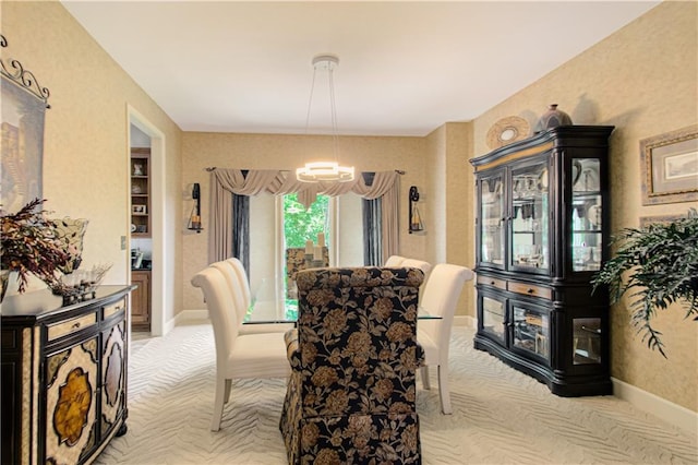 5445 NE Northgate Xing, Lees Summit, MO 64064 - dining space featuring light carpet, a chandelier, and baseboards