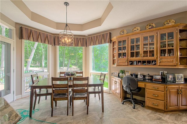 5445 NE Northgate Xing, Lees Summit, MO 64064 - dining area with a raised ceiling and a chandelier