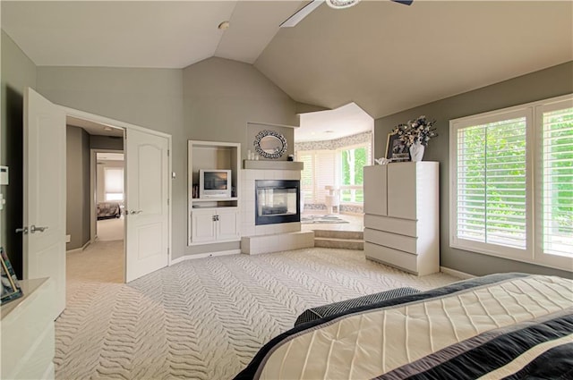 5445 NE Northgate Xing, Lees Summit, MO 64064 - bedroom with light carpet, lofted ceiling, a tile fireplace, baseboards, and a ceiling fan
