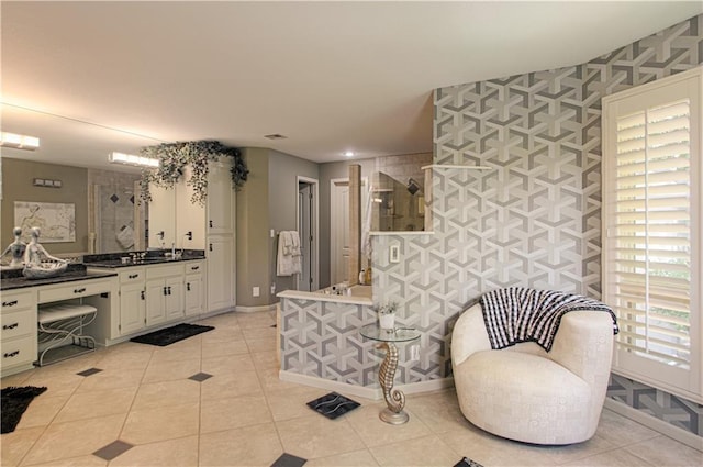 5445 NE Northgate Xing, Lees Summit, MO 64064 - bathroom featuring a tile shower, vanity, tile patterned floors, and baseboards