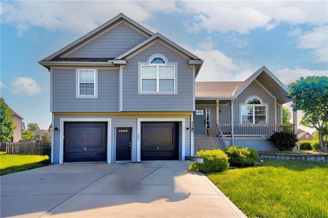 view of front facade with an attached garage, concrete driveway, and covered porch