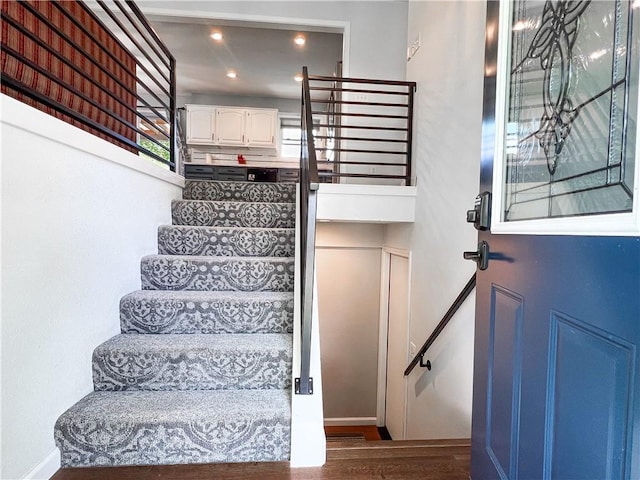 708 Cantebury Dr, Warrensburg, MO 64093 - stairs featuring wood finished floors, baseboards, and recessed lighting