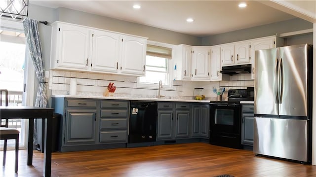 708 Cantebury Dr, Warrensburg, MO 64093 - kitchen featuring black appliances, gray cabinets, under cabinet range hood, white cabinets, and recessed lighting