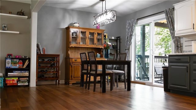 708 Cantebury Dr, Warrensburg, MO 64093 - dining space with dark wood-type flooring and a chandelier