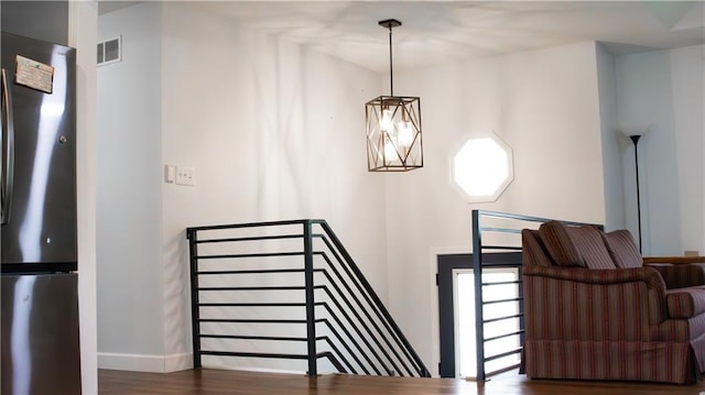 708 Cantebury Dr, Warrensburg, MO 64093 - stairway with wood finished floors and baseboards