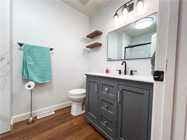 708 Cantebury Dr, Warrensburg, MO 64093 - full bath with vanity, toilet, wood finished floors, baseboards, and a shower