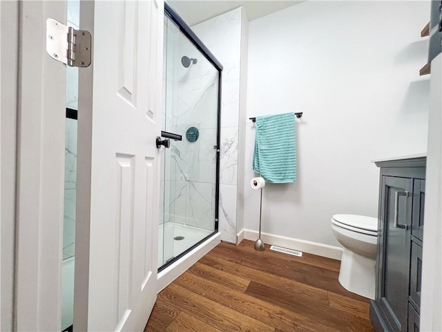 708 Cantebury Dr, Warrensburg, MO 64093 - bathroom with toilet, a shower stall, wood finished floors, and baseboards