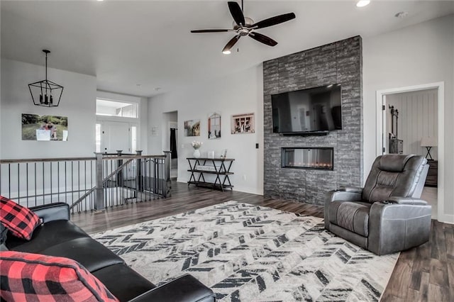 4713 NE Saratoga Ct, Lees Summit, MO 64064 - living room featuring wood finished floors, ceiling fan, a fireplace, and recessed lighting