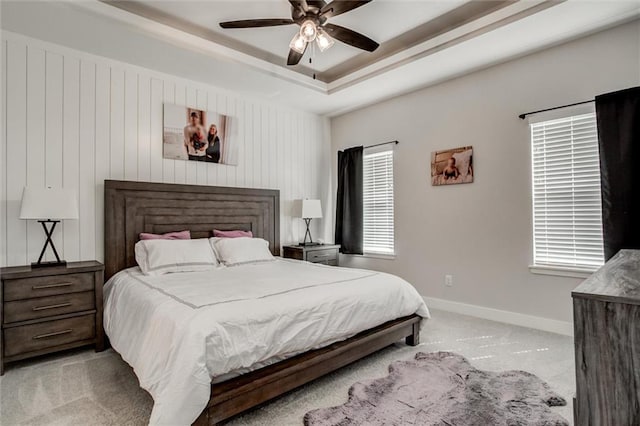 4713 NE Saratoga Ct, Lees Summit, MO 64064 - bedroom featuring light colored carpet, baseboards, a raised ceiling, and ceiling fan