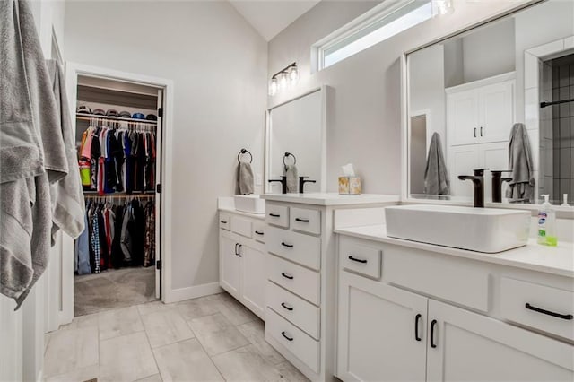 4713 NE Saratoga Ct, Lees Summit, MO 64064 - bathroom with vaulted ceiling, vanity, and a walk in closet