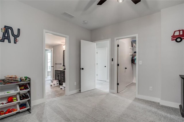 4713 NE Saratoga Ct, Lees Summit, MO 64064 - bedroom with a spacious closet, carpet floors, ensuite bath, baseboards, and ceiling fan