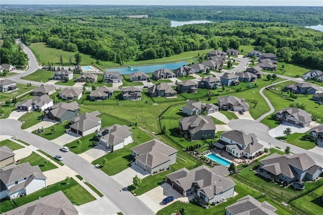 4713 NE Saratoga Ct, Lees Summit, MO 64064 - aerial view of property and surrounding area with a forest, a large body of water, and nearby suburban area