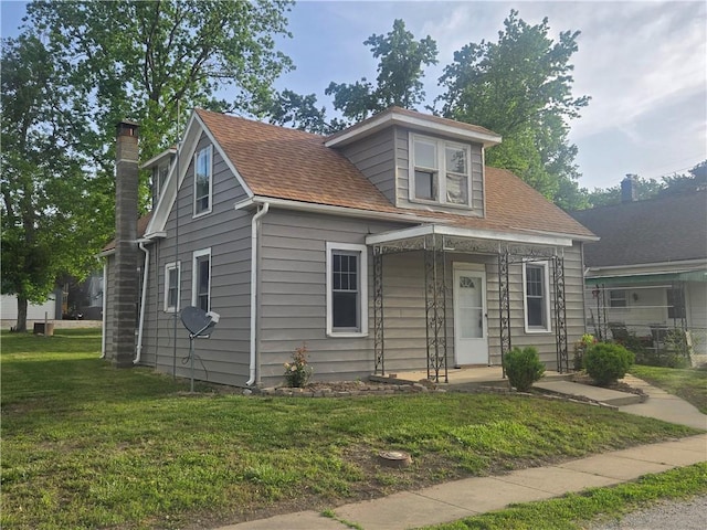 117 E Buford St, Wellington, MO 64097 - bungalow-style house featuring a front yard, a chimney, and roof with shingles