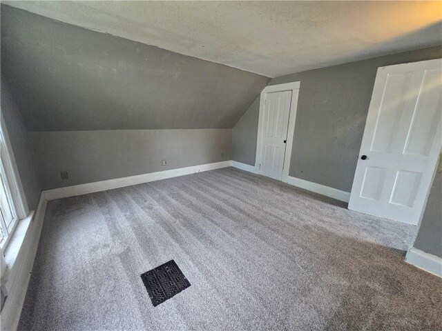 117 E Buford St, Wellington, MO 64097 - additional living space featuring carpet flooring, lofted ceiling, and baseboards